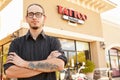 Portrait Of Tattoo Artist Standing Outside Parlor