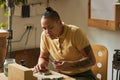 Tattooed female artisan creating handmade jewelry