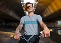 Portrait of tattooed young adult man on BMX bike