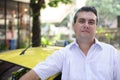 Portrait of a taxi driver with cab Royalty Free Stock Photo