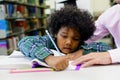 Portrait of teacher assisting little boy with homework in the li Royalty Free Stock Photo