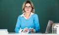 Portrait of teacher or business woman working at table in college or high school. Young women student studying in class. Royalty Free Stock Photo