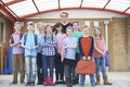 Portrait Of Teacher With Pupils In Playground