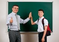 Portrait of a teacher and schoolboy playing at blackboard background - back to school and education concept Royalty Free Stock Photo