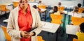Portrait of teacher with tablet in classroom Royalty Free Stock Photo