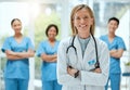 Portrait, team and a doctor woman arms crossed, standing in the hospital for healthcare or medicine. Leadership, medical Royalty Free Stock Photo