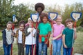 Portrait Of Team Leader And Group Of Children On Outdoor Activity Camp Catching Pond Wildlife