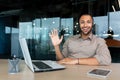 Portrait of tech support and online customer service worker, man with video call headset smiling and looking at camera Royalty Free Stock Photo