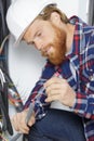 portrait technician connecting wire with screwdriver