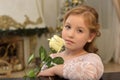 Portrait of a teen blonde with a white rose