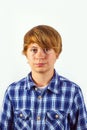 Portrait of a teen boy with blonde hair wearing a checked shirt