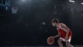 Portrait of teen boy, professional basketball player  over sport stadium background. Scoring winning goal Royalty Free Stock Photo