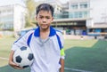 Portrait of teen boy in sportswear holding soccer ball, kid education sport concept Royalty Free Stock Photo