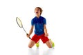 Portrait of teen boy in uniform, badminton player isolated over white background. Emotionally posing, winning Royalty Free Stock Photo