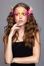 Portrait of teen girl with orchid flower in wavy hair Royalty Free Stock Photo
