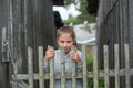 Portrait of teen girl near the wooden village fence. Summer.