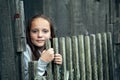 Portrait of teen girl over vintage rural fence.