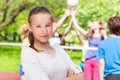 Portrait of teen girl with team playing volleyball