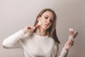 Portrait of teen model with stylish makeup holding contour brush