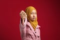 Portrait of teenage asian muslim girl looked disappointed while showing thumbs down gesture Royalty Free Stock Photo