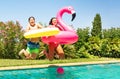 Cute boy and girl jumping into the swimming pool Royalty Free Stock Photo