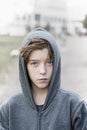 Portrait of a teenage boy with grey hoodie sweatshirts