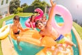 Cute boy having fun with friends in swimming pool Royalty Free Stock Photo