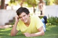 Portrait Of Teenage Boy Laying In Park Royalty Free Stock Photo