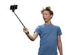 Portrait of teenage boy is taking selfie on his smartphone. Royalty Free Stock Photo