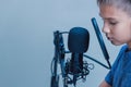 Portrait of teenage boy wearing headphones using microphone Royalty Free Stock Photo