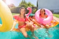 Joyful teens having pool party during summertime Royalty Free Stock Photo