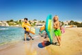 Teenage boys running along sandy beach in summer Royalty Free Stock Photo