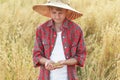 Portrait of teenage farmer boy is checking oat or Avena sativa seeds in cupped palms