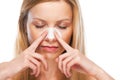 Portrait of teenage girl applying clear-up strips on nose Royalty Free Stock Photo