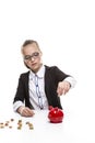 Portrait of Teenage Girl in Dark Jacket Putting Coin Into The Piggybank For Savings Royalty Free Stock Photo