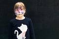 Portrait of a teenage girl with face painting in the form of a cat mask at a children`s party Royalty Free Stock Photo