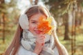 Portrait teenage girl with fall leaves looking at camera wearing casual clothes in an autumn park outdoors Royalty Free Stock Photo