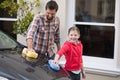 Teenage girl and father washing a car Royalty Free Stock Photo