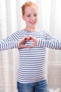 Portrait teenage girl forming heart shape with hands Royalty Free Stock Photo