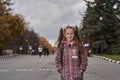 Portrait of a teenage girl with glasses, with a rucksack and white bows on the way to school in the mornin Royalty Free Stock Photo