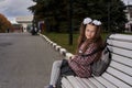 Portrait of a teenage girl with glasses, with a rucksack and white bows on the way to school in the morning Royalty Free Stock Photo