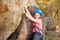 Young mountaineer training rock climbing outdoors