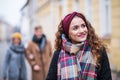 A portrait of teenage girl with headband and scarf on the street in winter. Royalty Free Stock Photo