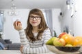 Portrait of teenage girl holding apple at home Royalty Free Stock Photo