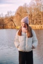 Portrait teenage girl looking away wearing casual fall clothes in an autumn park with lake outdoors Royalty Free Stock Photo