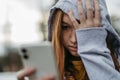 Portrait of teenage girl looking at her smartphone, sad, anxious, alone. Cyberbullying, girl is harassed, threated Royalty Free Stock Photo