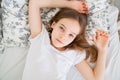 Teenage girl lying in bed idle in quarantine.