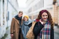 A portrait of teenage girl with paper shopping bags on the street in winter. Royalty Free Stock Photo