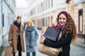 A portrait of teenage girl with paper shopping bags on the street in winter. Royalty Free Stock Photo