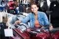 Portrait of teenage girl picking new big plastic luggage bag wit